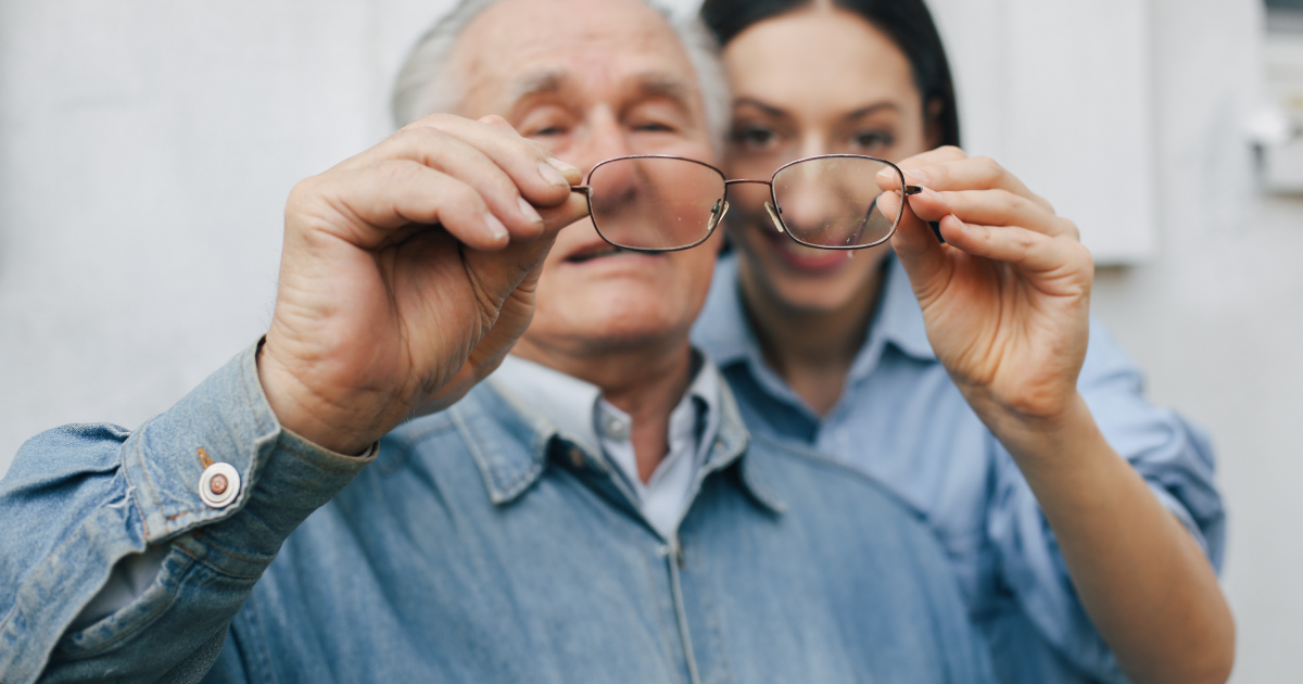 Doctor helping an elderly man with glasses